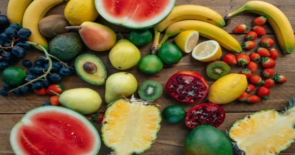 A mix of fruits including banana, berries, citrus, and melon showing variety in daily nutrition