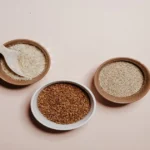 Whole grains in bowls including rice, quinoa, and buckwheat used in daily meals